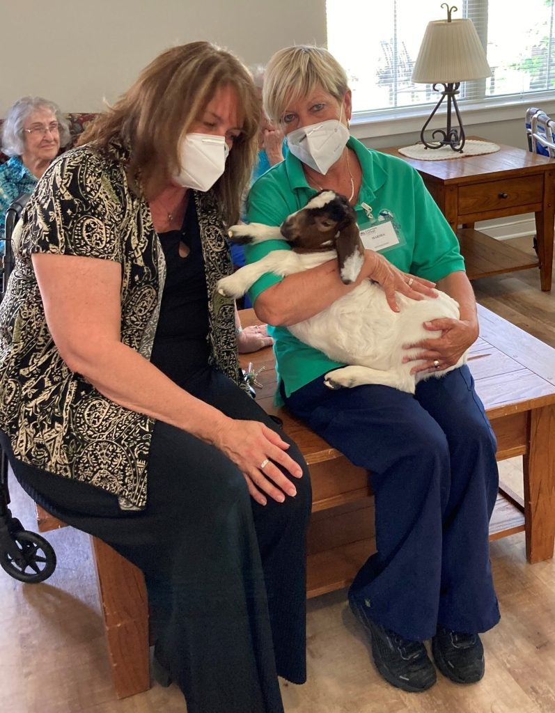 Residents and staff with baby goats