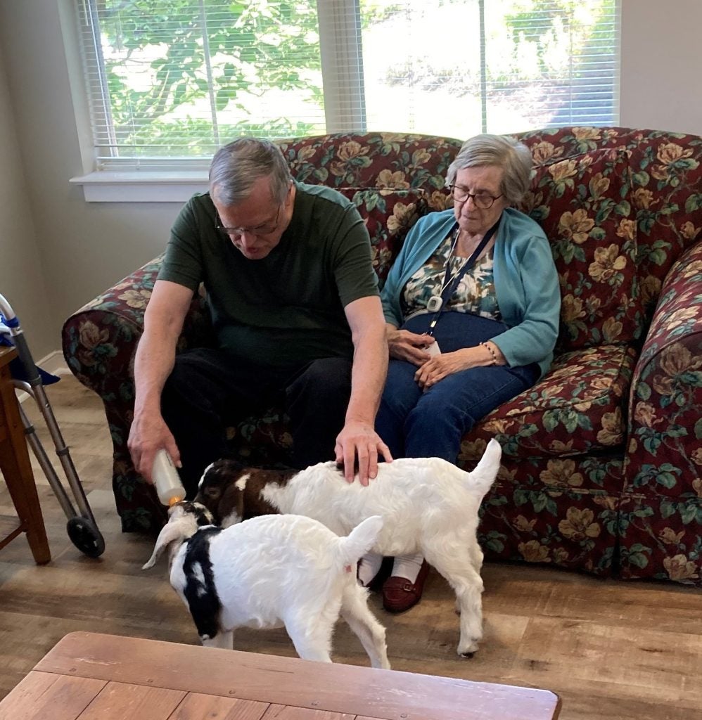 Residents and staff with baby goats