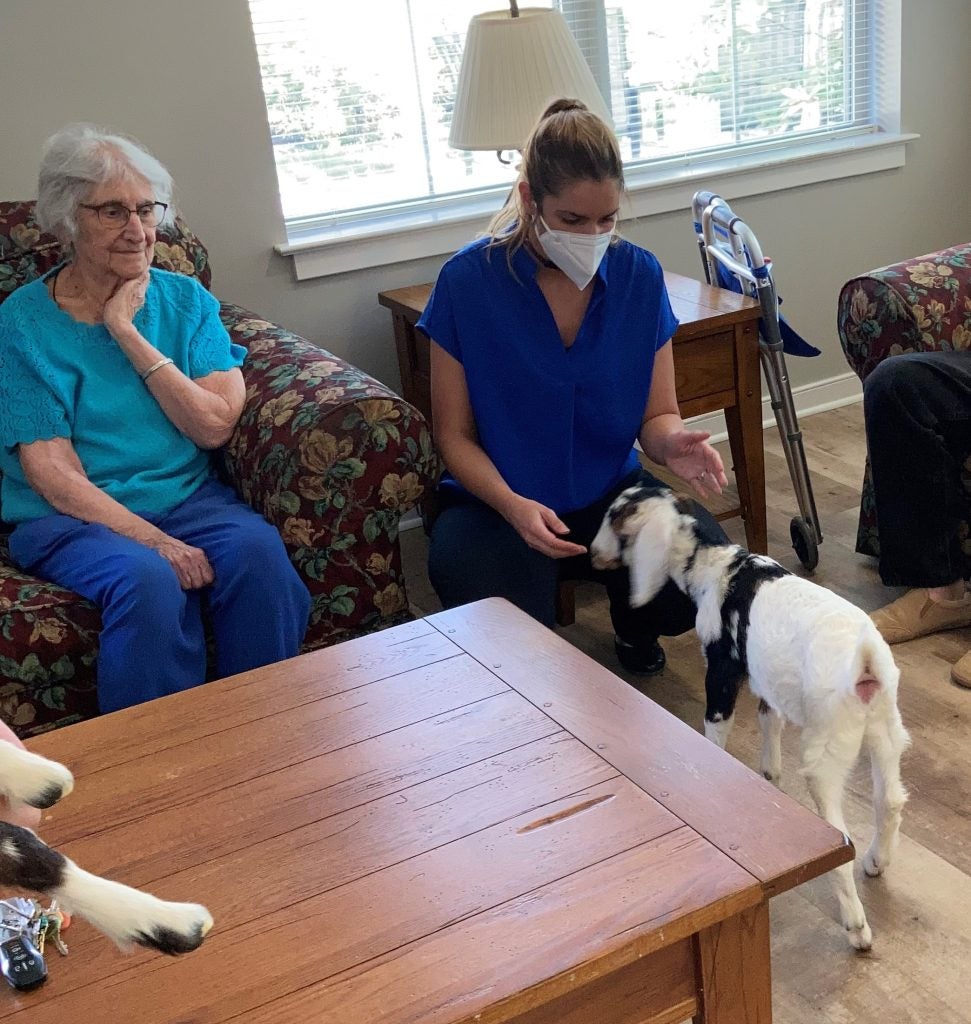 Residents and staff with baby goats