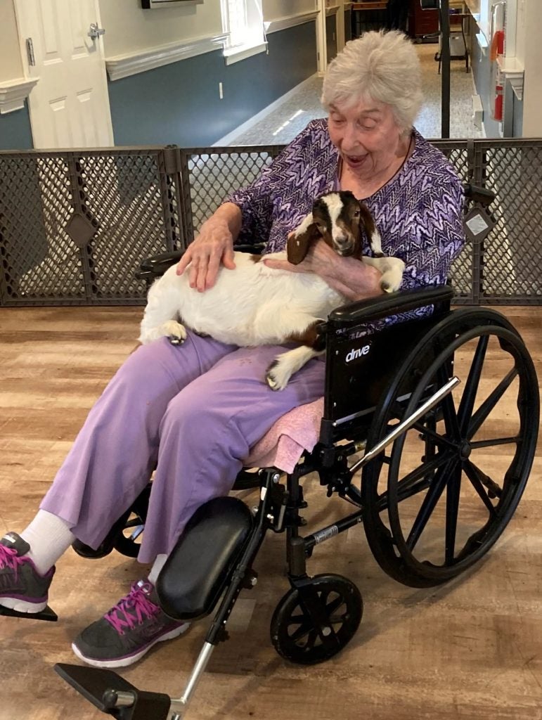 Residents and staff with baby goats