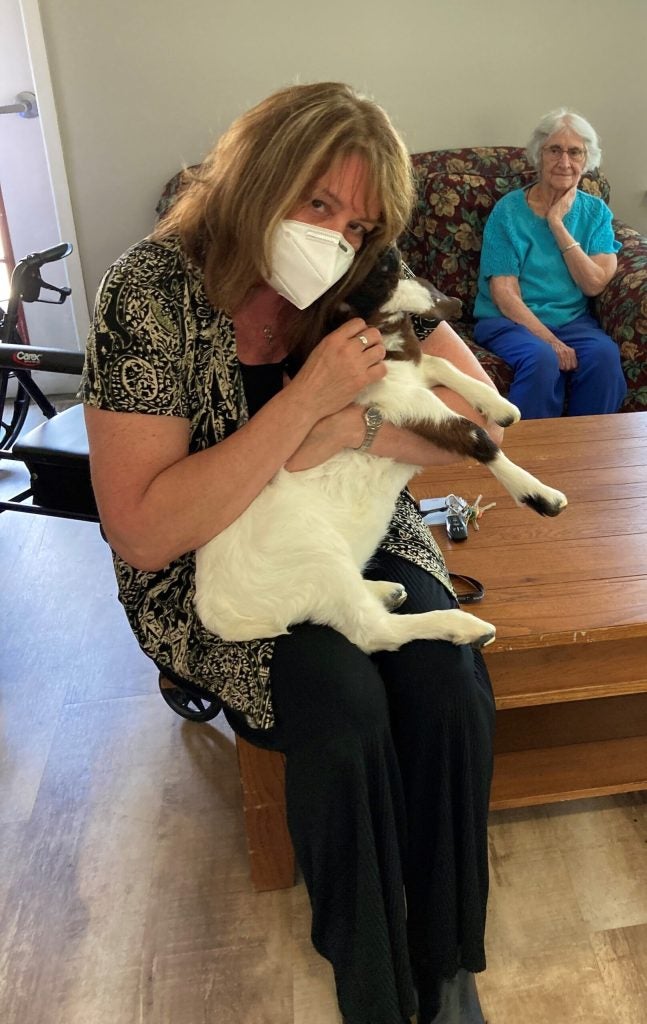 Residents and staff with baby goats