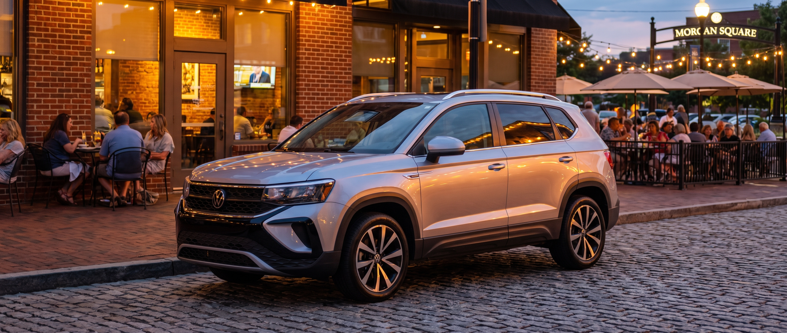 2026 Volkswagen Taos parked near downtown Spartanburg SC restaurant district along Morgan Square at dusk