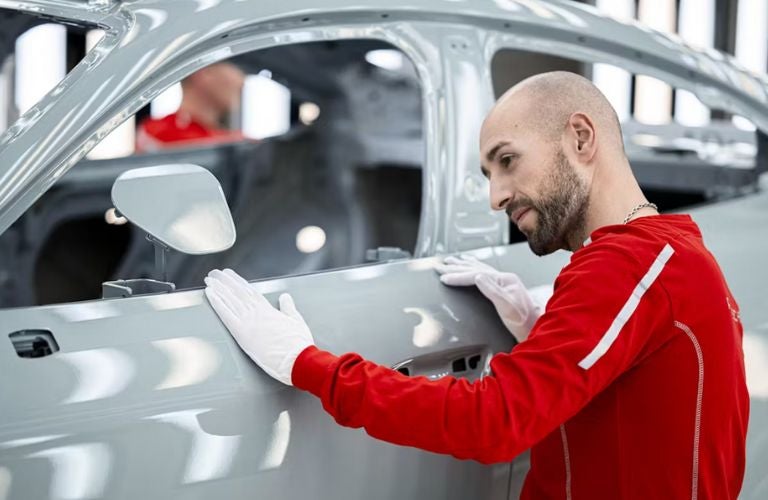 A man checking the exterior of the new Taycan
