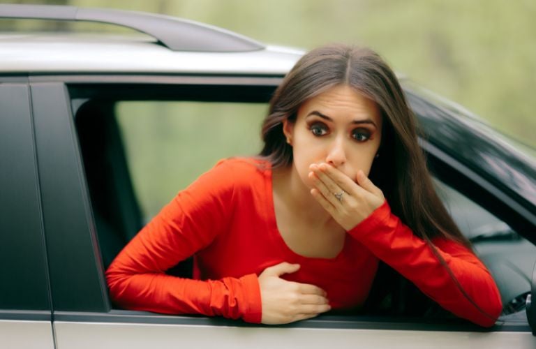 Woman having motion sickness symptoms