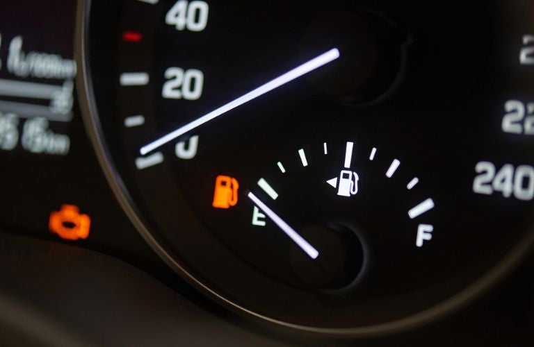 Close up view of a fuel gauge showing low fuel