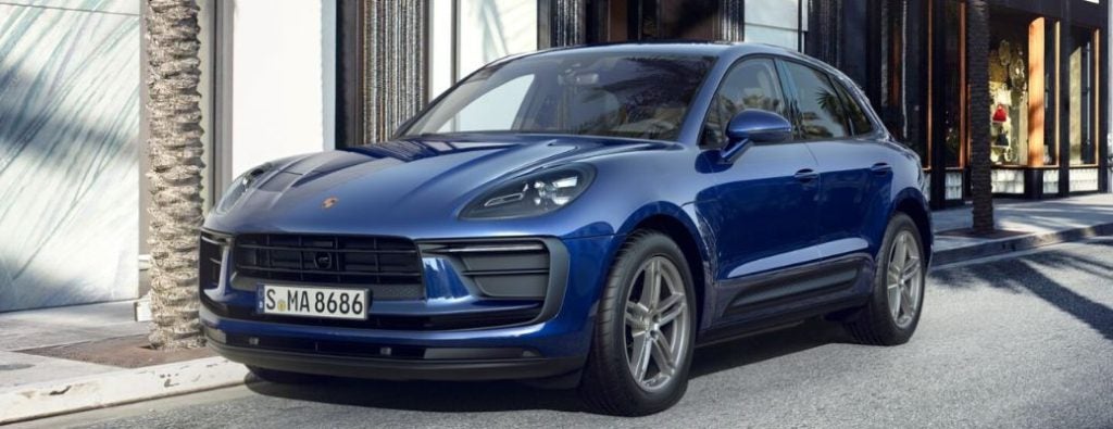 Porsche car parked outside modern house.