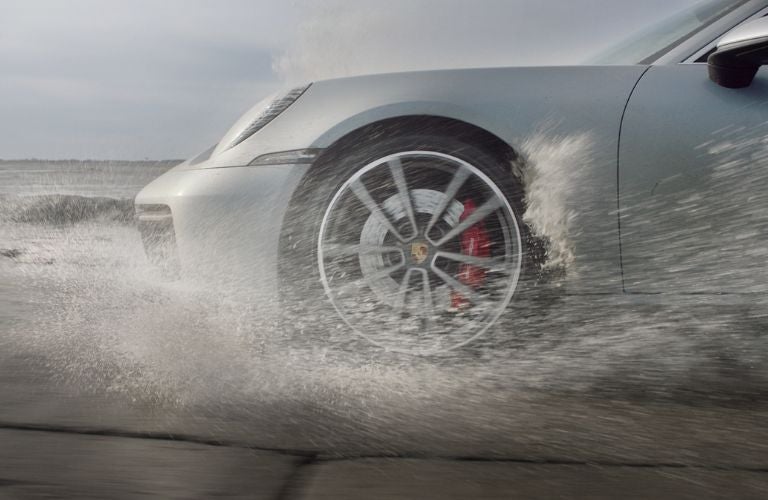 a Porsche front wheel in rain
