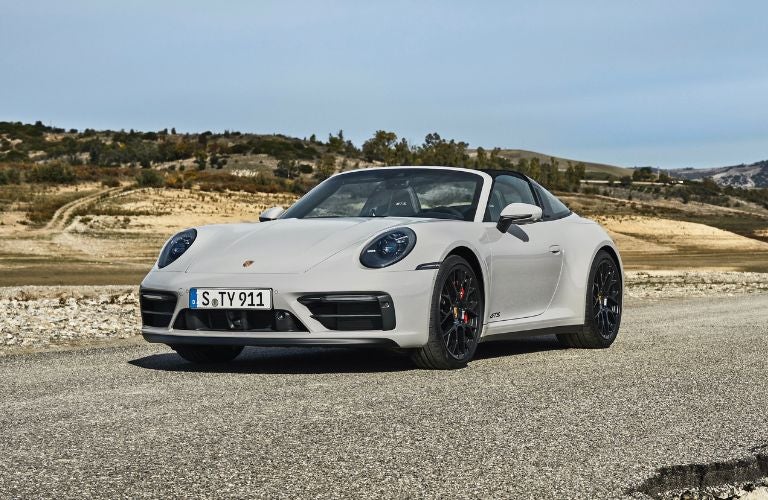 Porsche car parked on nice road.