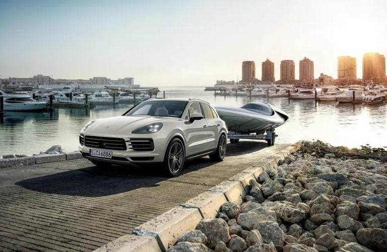 2022 Porsche Cayenne towing a boat.