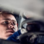Man is fixing suspension system