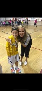 Mother and daughter hugging with a medal