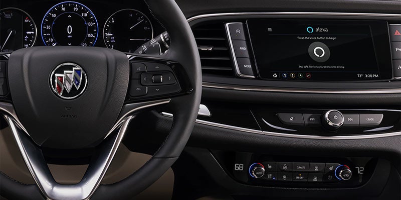 Buick vehicle interior showing steering wheel, digital instrument cluster