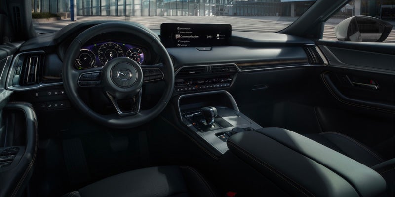 Mazda CX-series SUV interior with digital instrument cluster, infotainment display, and premium driver-focused cockpit.