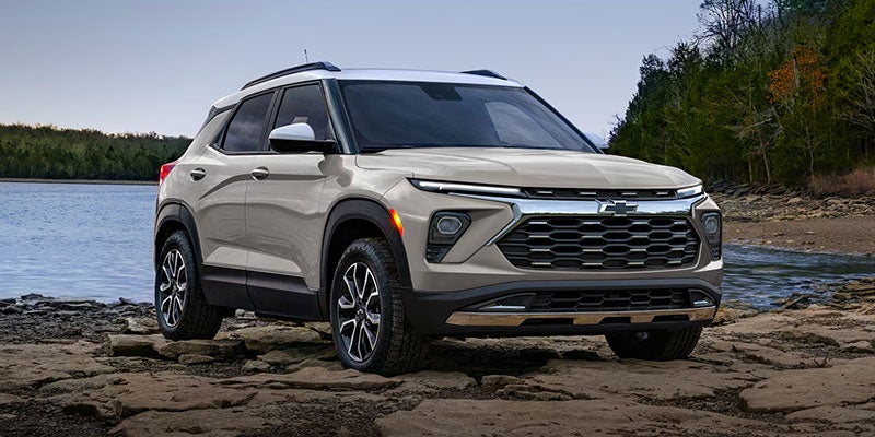 Chevrolet Trailblazer SUV parked along a rocky waterfront, showcasing its bold design, elevated ground clearance