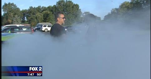 Richard Rawlings beside a Dodge Hellcat doing a burnout
