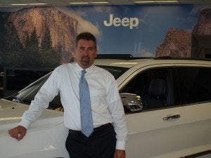 Cueter general manager Steve Demers standing beside a Jeep