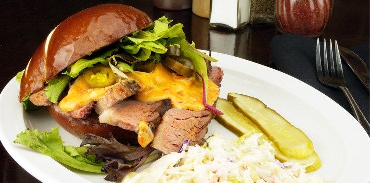 Pulled pork sandwich served with a pickle