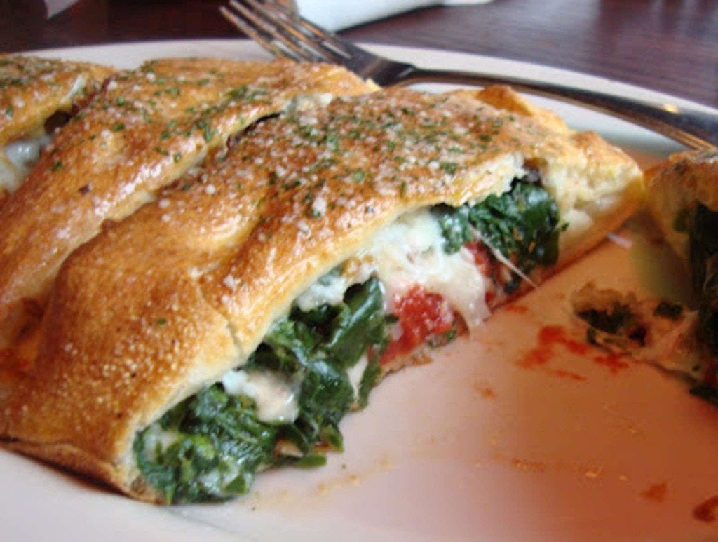 Sliced stuffed pizza filled with spinach