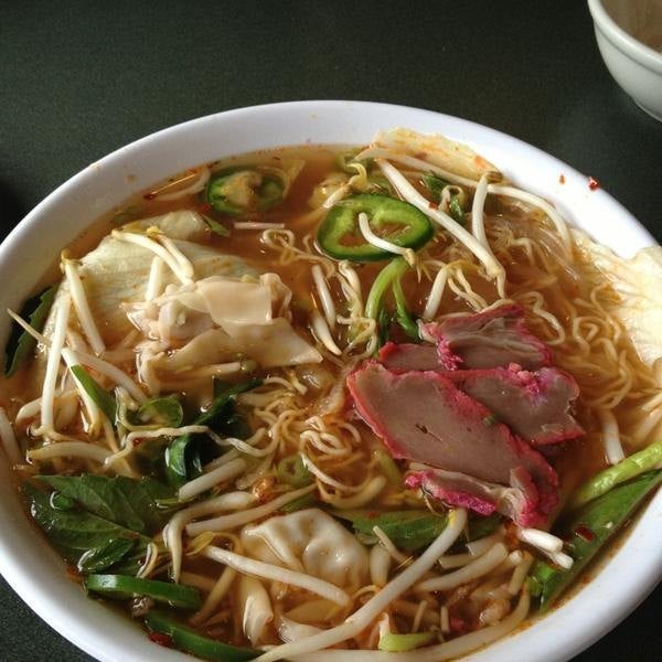 Bowl of pho soup with beansprouts and herbs