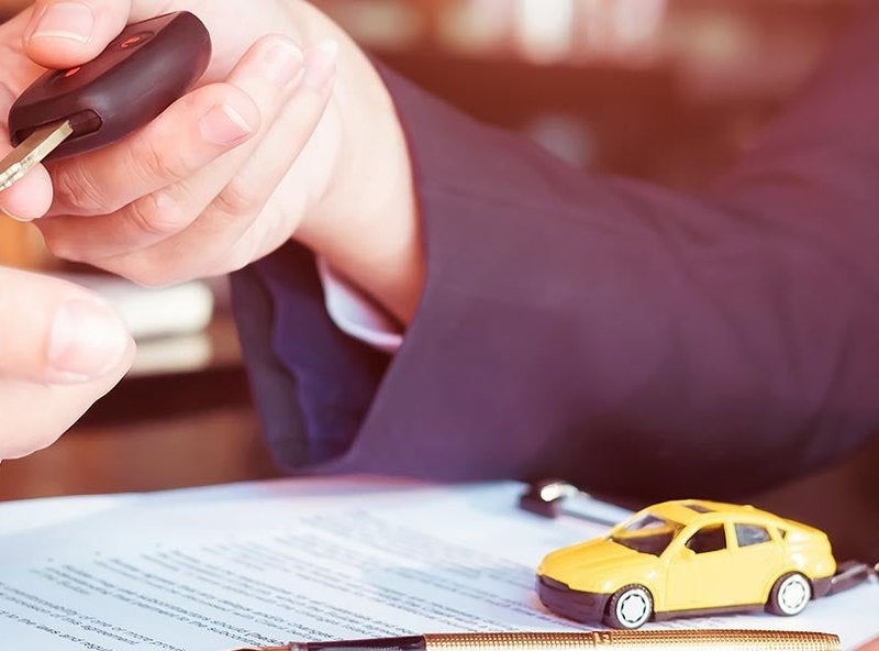 Car keys being handed to a customer