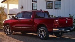 Dark red 2019 Ram 1500 parked by a barn, rear view