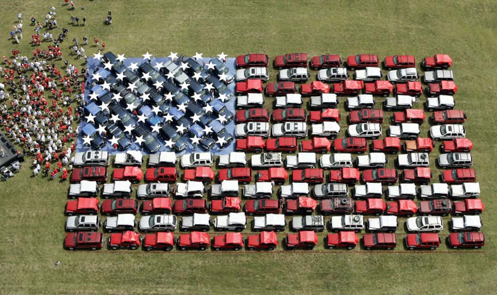 Aerial view of 140 Jeeps parked in the shape of an American flag in a field in Mount Pocono, Pennsylvania