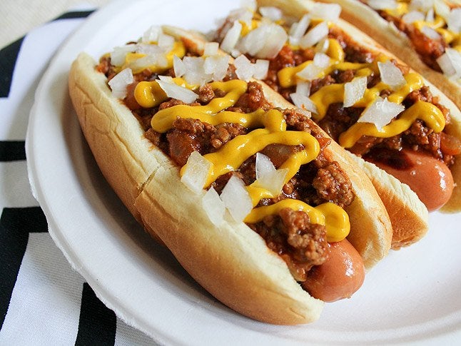 Two coney dogs topped with chili, onions and mustard