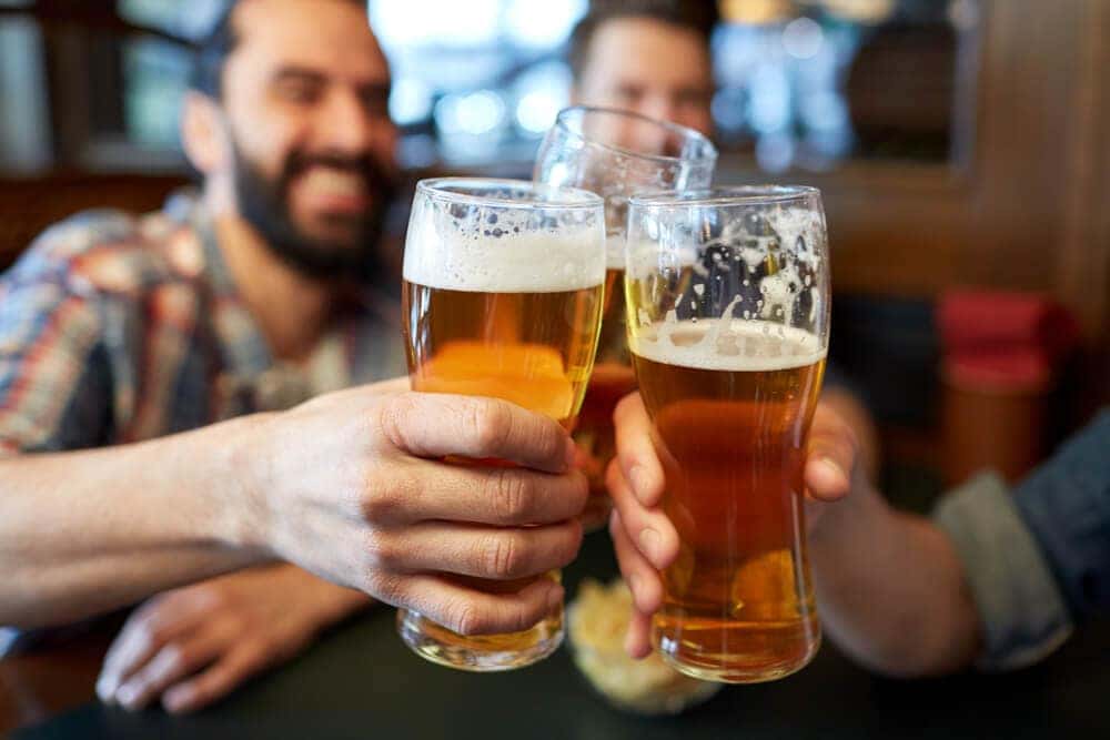 Friends Hanging out at Bar with Beers