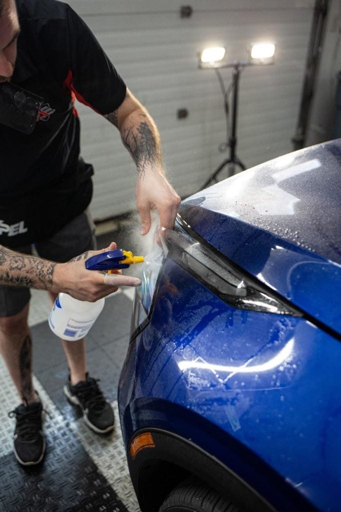 Matt applying PPF to headlight of 2023 Kia Sportage