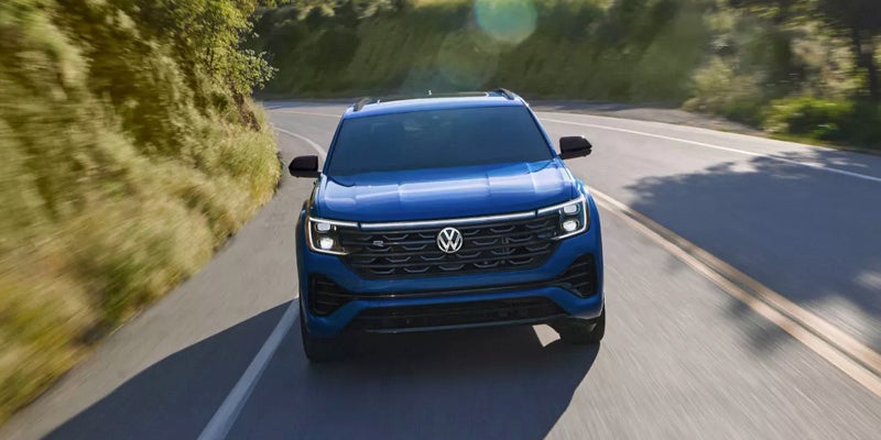 Blue Volkswagen Atlas on road