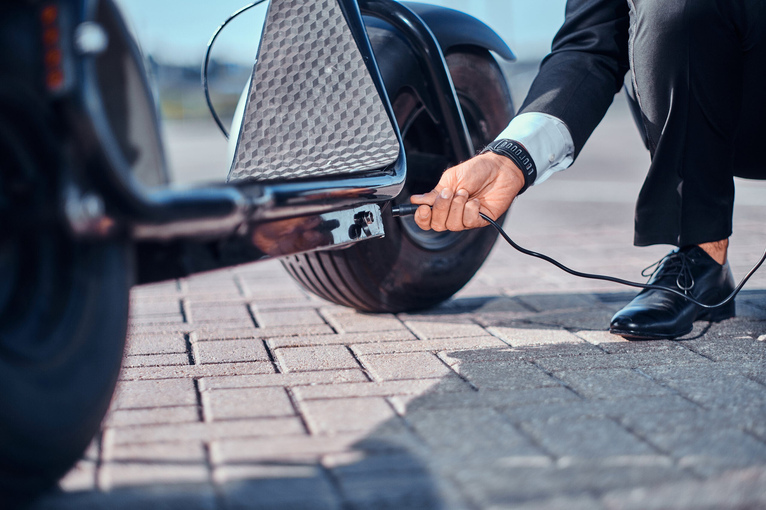 Man is charging his new electro scooter