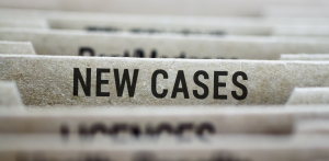 File folders with a visible tab labeled New Cases in bold black letters