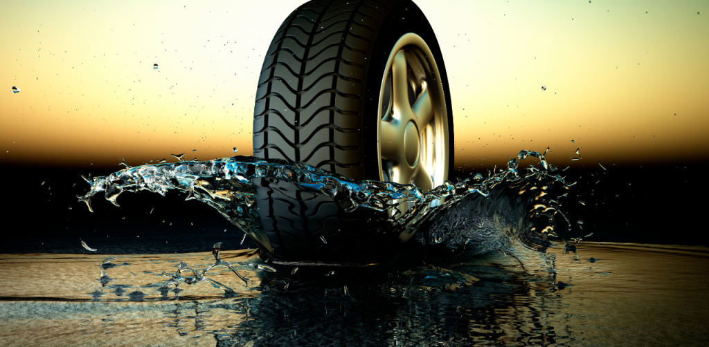 Car tire splashing through water at high speed, symbolizing dangerous driving conditions that may require a car accident lawyer