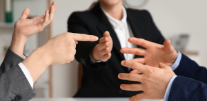 Heated business dispute with hands gesturing during negotiation, representing conflict resolution, mediation, or legal disagreement