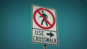 Traffic sign instructing pedestrians to use the crosswalk