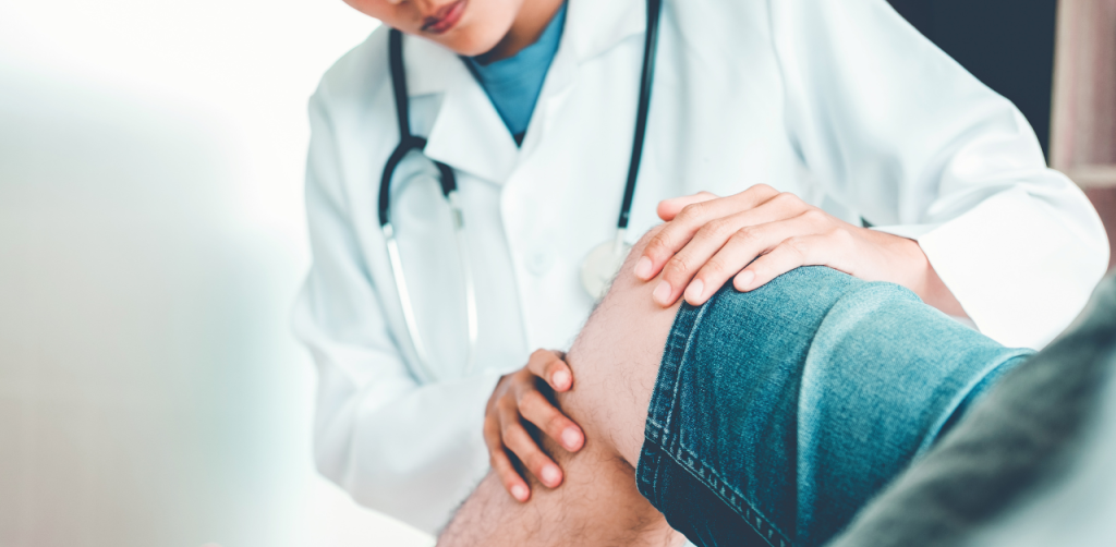Doctor examines a patient’s injured knee, documenting medical evidence for a legal settlement case
