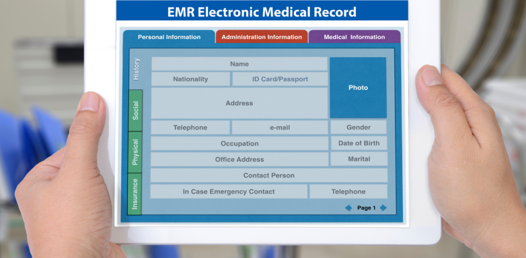 Hands holding tablet showing an electronic medical record form with patient personal information fields