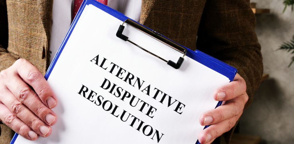 Man holding clipboard labeled Alternative Dispute Resolution