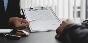 Insurance agent reviewing auto insurance policy with client