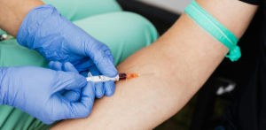 Medical professional drawing blood from patient for testing