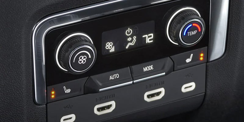 Car climate control panel with two rotary dials, a digital display showing '72', and heated seat, USB-C, and HDMI ports.