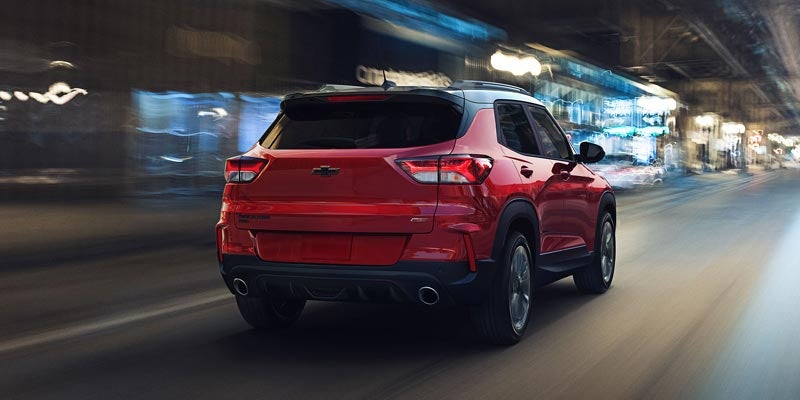 A Chevy Blazer is shown from the back driving .