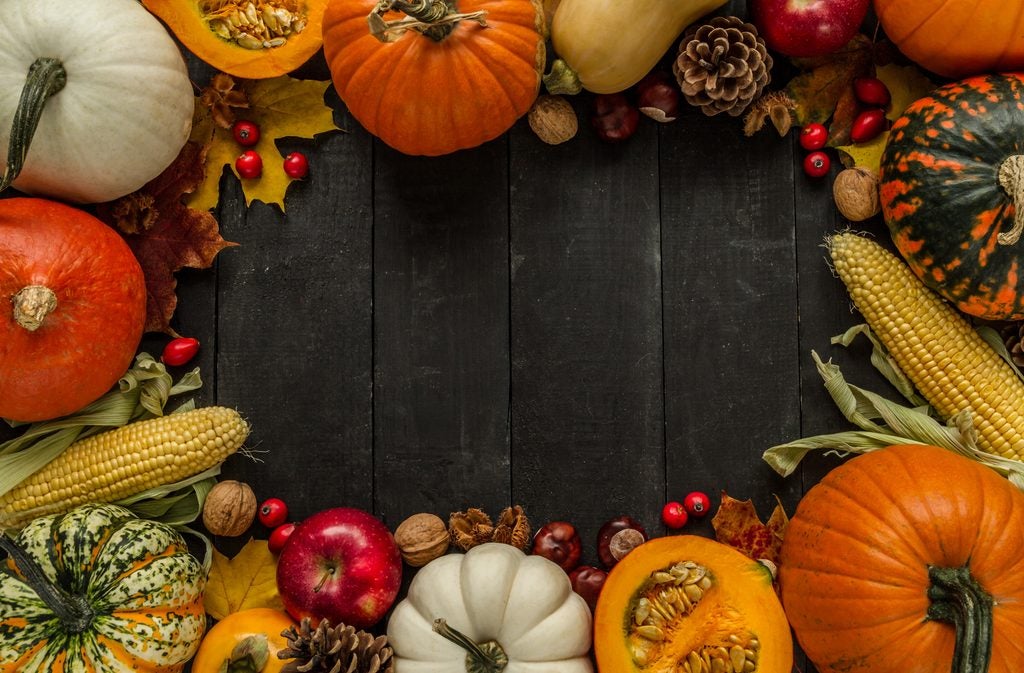 A dark wooden tabletop/background occupies the center of the image, leaving ample empty space for text or promotional content.