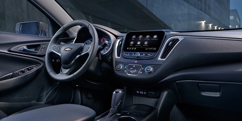 Interior dashboard, infotainment screen, steering wheel, and center console