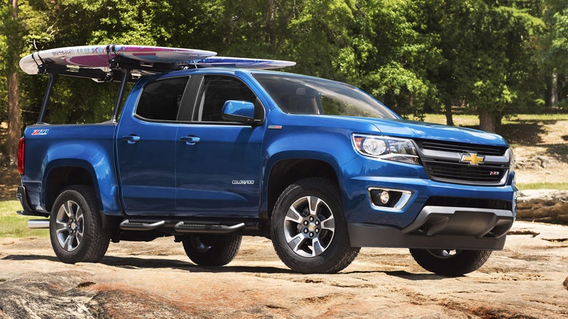 a blue Chevrolet Colorado pickup truck in an outdoor recreational setting.