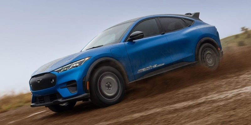Blue Ford Mustang Mach-E on a dirt trail