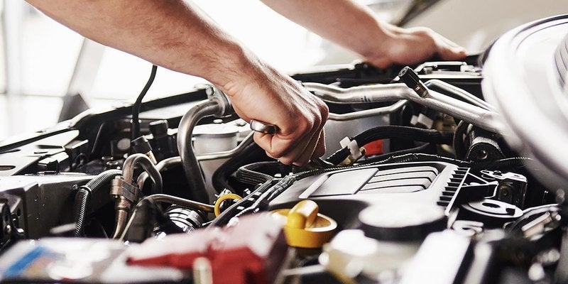 Technician working on a vehicle engine