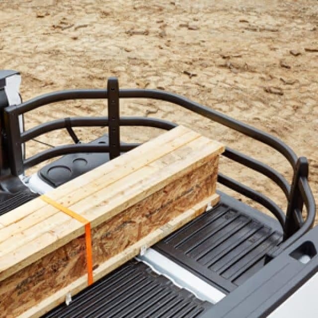 Pickup truck bed extender holding lumber