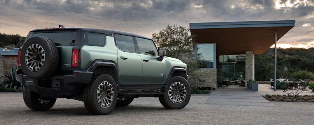2024 GMC Hummer EV SUV parked outside of house