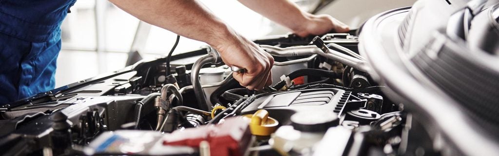 Service technician inspecting a car